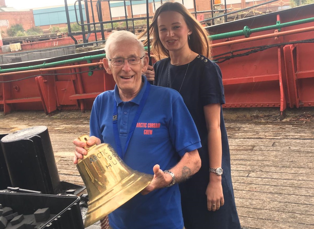 Trevor Evans, the longest-serving volunteer, and intern Abigail Jubb with the Arctic Corsair bell.