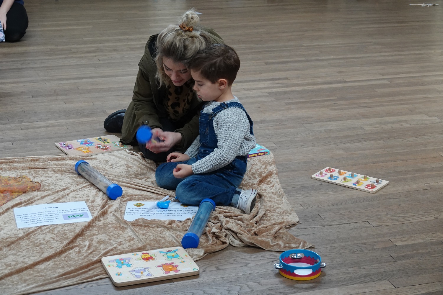 A parent and child play together.