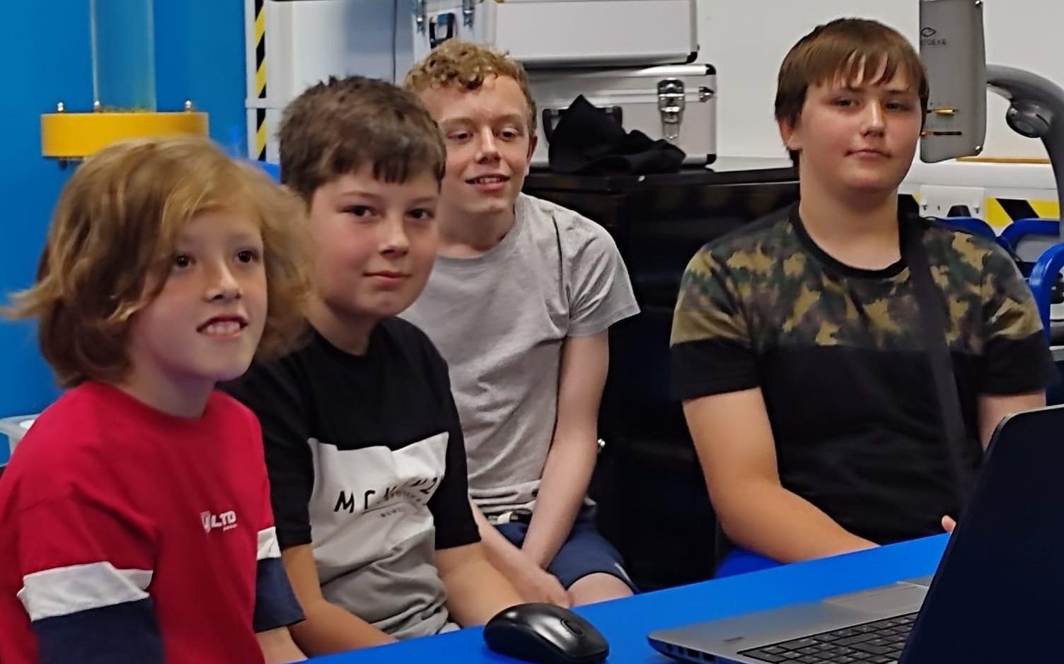 From left, Georgii Dodukh, Maksym Larchikov, Luke Attwater and Nicholas Tarasenko playing chess at a laptop